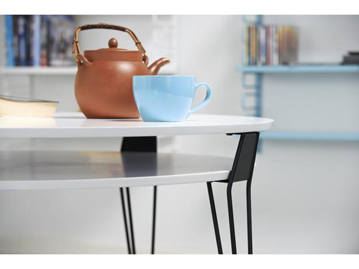 white round designer coffee table with black metal hairpin legs