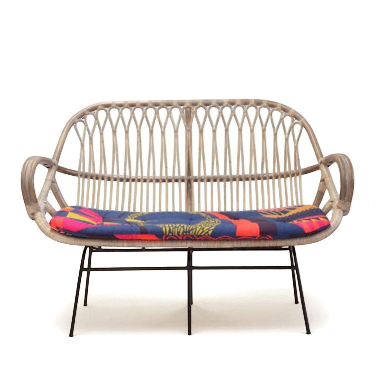 2-seater wicker bench with colorful patterned cushion, curved backrest, and slim metal legs — ideal for outdoor or patio seating.