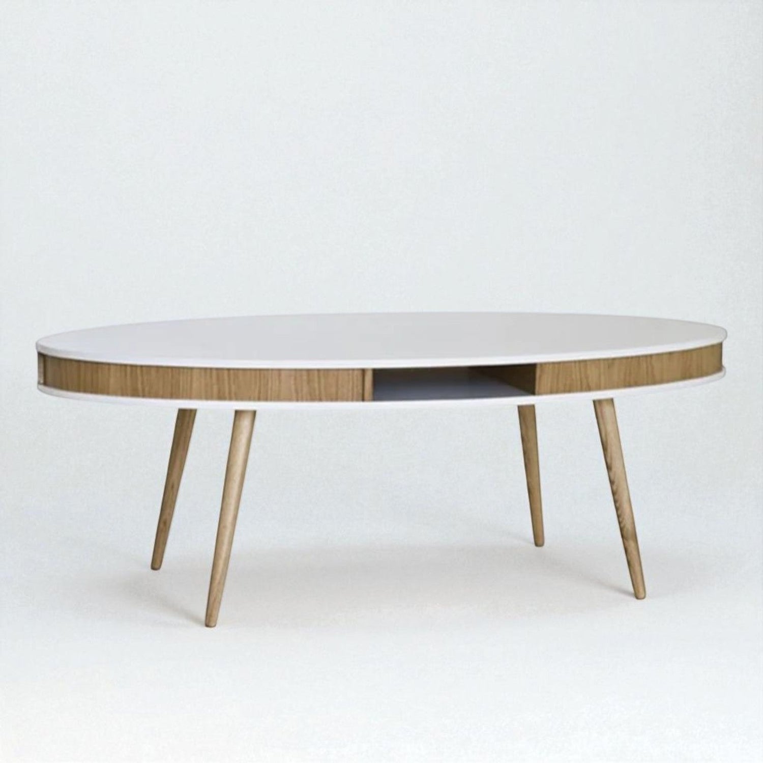 Modern oval coffee table with white top, wooden legs, and built-in side storage compartment — minimalist and functional design.