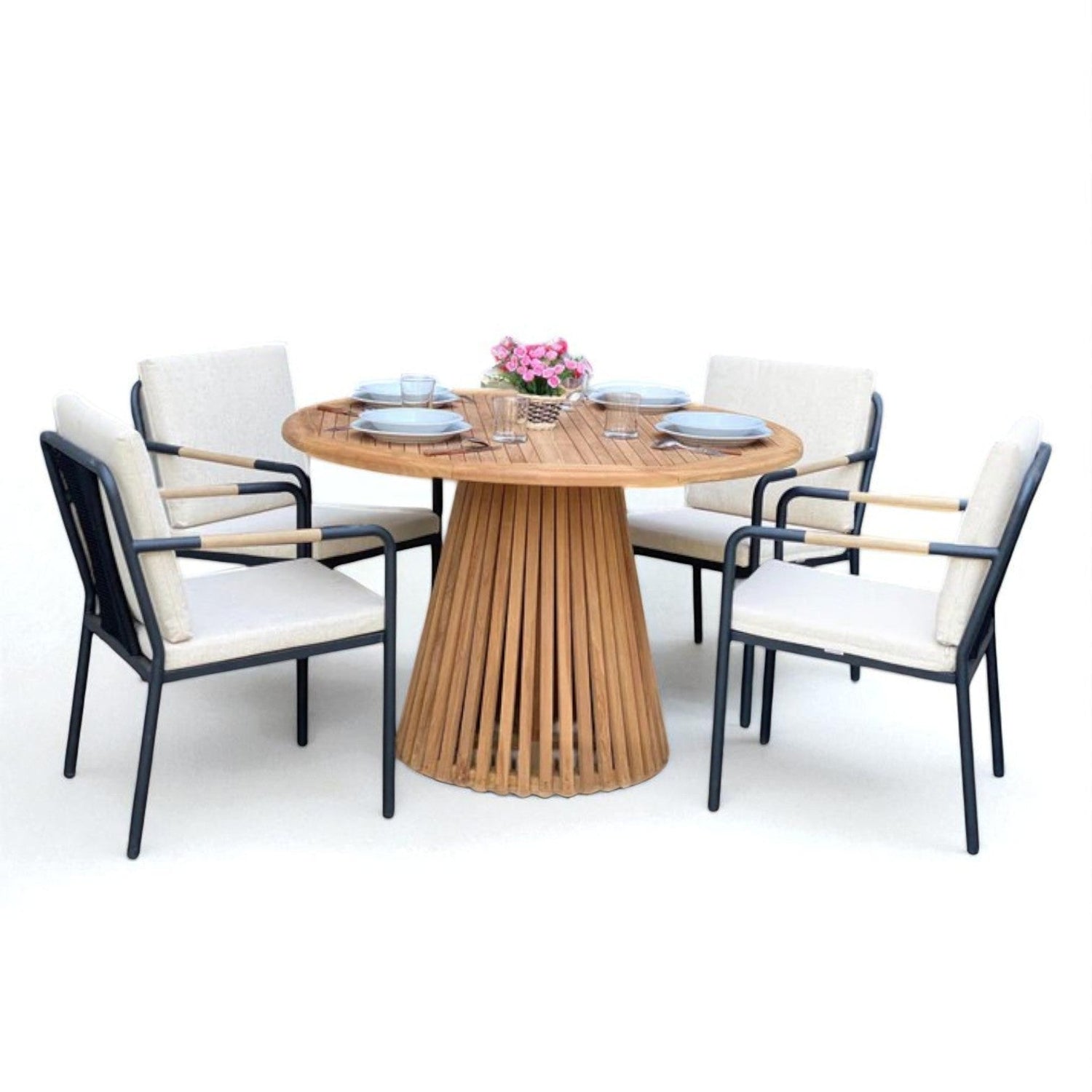Outdoor dining set with round wooden table featuring slatted base, four cushioned chairs with black metal frames, and tableware for four — ideal for patio or garden use.