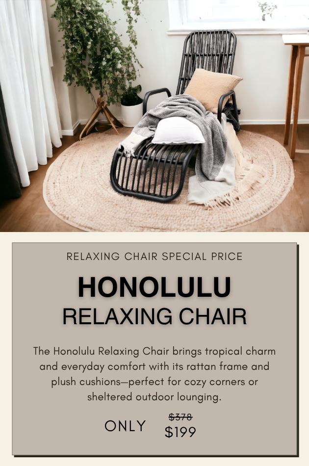 Honolulu Relaxing Chair made of black rattan with soft cushions, styled in a sheltered outdoor space for cozy tropical lounging.