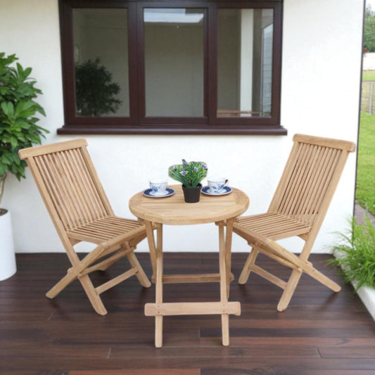 Teak outdoor balcony set featuring two Java Folding Chairs and a Cilacap Side Table with hexagonal top, styled with patterned teacups and potted flowers for a cozy patio vibe.