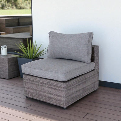 Stylish outdoor seating with gray cushioned wicker chair and garden-inspired decor