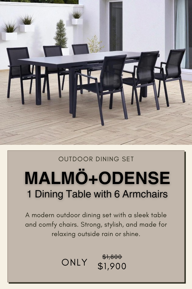 Outdoor dining set featuring a long rectangular table and eight black mesh chairs, placed on a wooden deck in front of a white house with large windows. Surrounded by greenery, the setting highlights a modern, Scandinavian-inspired design ideal for open-air gatherings.