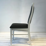 Landsort Dining Chair featuring a sleek, minimalist design with a sturdy wood frame and comfortable fabric upholstery, perfect for modern dining spaces.