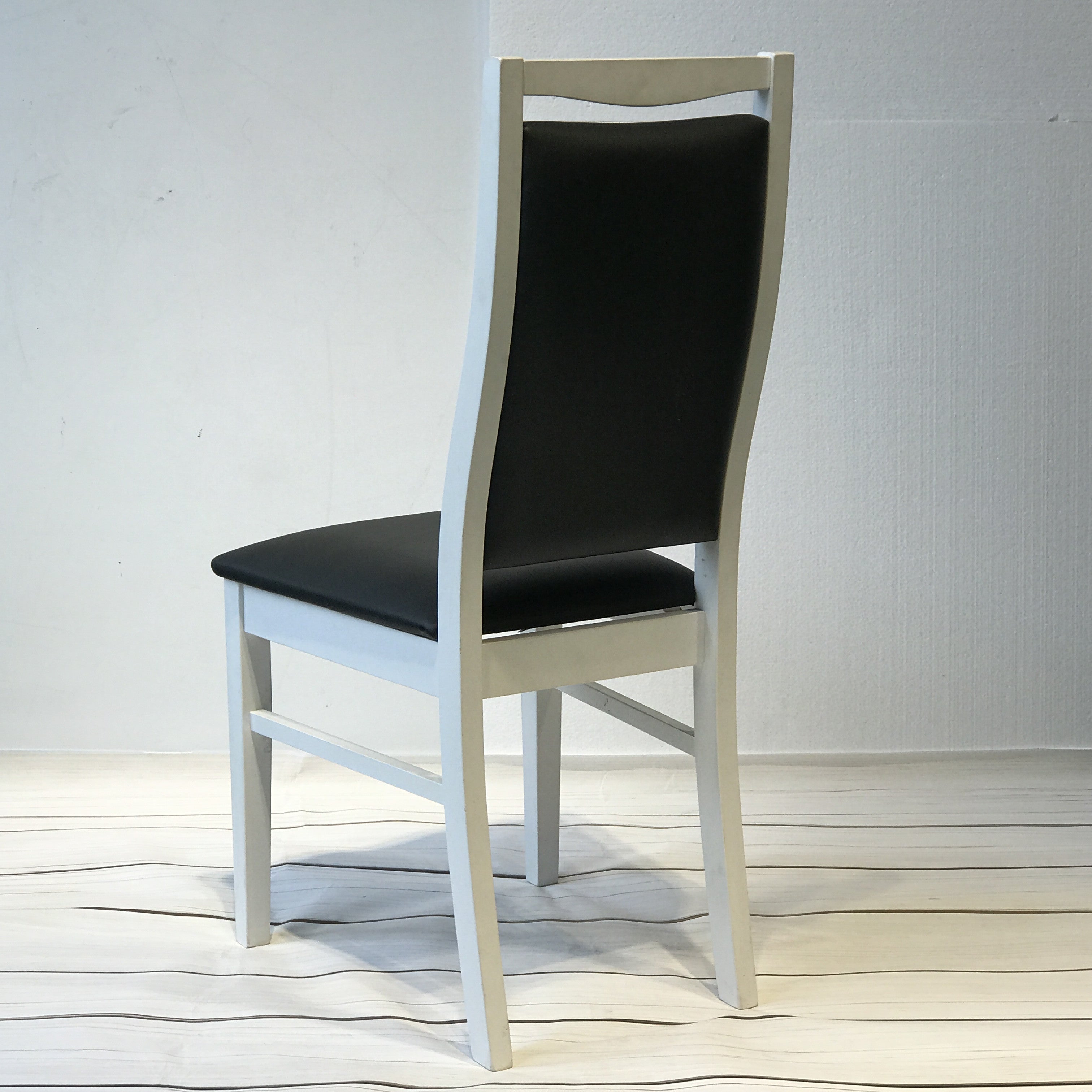 Landsort Dining Chair featuring a sleek, minimalist design with a sturdy wood frame and comfortable fabric upholstery, perfect for modern dining spaces.
