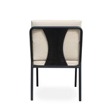 Hollviken outdoor dining chair with black metal frame, beige cushions, and wooden armrests on a modern patio deck.