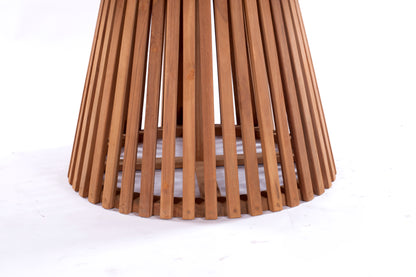 Nusa Dua round wooden outdoor dining table with slatted base, styled with white tableware and floral centerpiece on a garden patio deck.