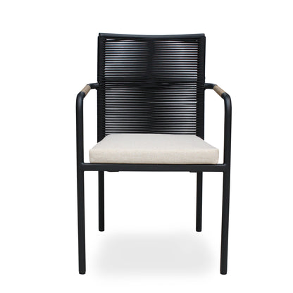 SKANÖR outdoor chair with black metal frame, wooden armrests, and beige cushion, ideal for modern patio or balcony seating